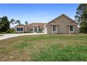 Single-story home featuring a large front lawn and concrete driveway leading to the attached garage at 2048 Laredo Dr, Deltona, FL 32738