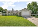 Charming one story home featuring a manicured lawn, neutral paint, and an attached two-car garage at 227 Heronwood Cir, Deltona, FL 32725
