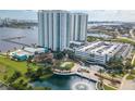 Aerial view of condo buildings with beautiful landscaping, a water feature, and convenient parking at 241 Riverside Dr # 2110, Daytona Beach, FL 32117