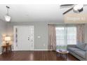 Bright living room boasts lots of natural light, hardwood floors, and neutral paint at 2466 Candlewick St, Deltona, FL 32738