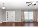 Open-concept living room features hardwood floors, a decorative front door, and ample natural light at 2466 Candlewick St, Deltona, FL 32738