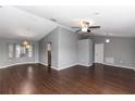 Spacious living room with vaulted ceiling, hardwood floors, and ample natural light from large windows at 2466 Candlewick St, Deltona, FL 32738