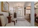 Bright foyer with white tile, front door with decorative glass, and stairs to dining room at 2542 S Peninsula Dr, Daytona Beach, FL 32118