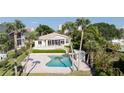 Private backyard oasis featuring a sparkling pool and lush tropical landscaping at 2542 S Peninsula Dr, Daytona Beach, FL 32118