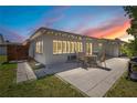 Outdoor patio with table and chairs, with view of the home's backyard and shuttered windows at 2565 S Peninsula Dr, Daytona Beach, FL 32118