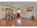 Elegant dining room with hardwood floors, wooden table, chairs, and charming furnishings at 261 Clydesdale Cir, Sanford, FL 32773