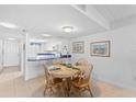 Cozy dining area with wood table, tile floors, and open to kitchen at 2626 S Atlantic Ave # 1080, Daytona Beach, FL 32118