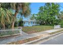 Light blue home with white picket fence, showcasing its curb appeal in a sunny setting at 263 Seaview Ave, Daytona Beach, FL 32118