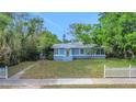A light blue single-story home featuring a well-manicured lawn and mature trees at 263 Seaview Ave, Daytona Beach, FL 32118
