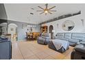 Spacious living room featuring tile floors, large windows, modern furnishings and a ceiling fan at 3109 Sky St, Deltona, FL 32738