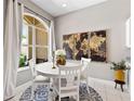 Bright dining area features a white table set, decorative artwork, and a view to the inviting outdoor space at 3140 Kailani Ct, Ormond Beach, FL 32174