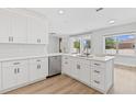 Modern kitchen features white cabinets, stainless steel appliances, and a large center island at 3333 Atmore Ter, Ocoee, FL 34761