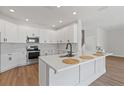 Bright, modern kitchen with white cabinets, stainless steel appliances, and a center island at 3333 Atmore Ter, Ocoee, FL 34761