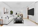 Bright living room featuring a comfortable L-shaped sofa, modern art, and a sleek black coffee table at 3333 Atmore Ter, Ocoee, FL 34761