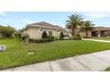 Well-maintained single-story home featuring a lush lawn and mature landscaping at 3470 Tesoro Cir, New Smyrna Beach, FL 32168