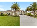 Beautiful single-story home with well-manicured lawn and a long driveway at 3470 Tesoro Cir, New Smyrna Beach, FL 32168