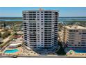 Exterior of tall beachfront condo building with ocean views and private parking lot at 3855 S Atlantic Ave # 405, Daytona Beach, FL 32118