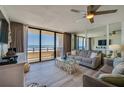 Bright living room with expansive ocean views, comfortable seating, and a sliding glass door to balcony at 3855 S Atlantic Ave # 405, Daytona Beach, FL 32118