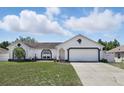 Charming single-story home with a well-maintained lawn and a two-car garage at 417 Jeffers St, Deltona, FL 32725