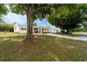 Well-maintained home featuring lush greenery and a covered carport, exuding curb appeal at 44 Florence Blvd, Debary, FL 32713