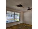 Living room featuring a ceiling fan, and a large window overlooking the backyard at 461 Marigold Rd, Casselberry, FL 32707
