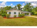 Single-story home featuring manicured landscaping, a new roof, and a covered carport at 508 W Hogle Ave, Deland, FL 32720