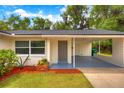 Exterior shot of a single-story home with a covered carport and nicely landscaped walkway at 508 W Hogle Ave, Deland, FL 32720