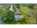 Aerial view of a home with solar panels backing onto a lush golf course in a tranquil neighborhood at 5097 Nw 19Th Pl, Ocala, FL 34482