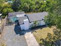 Aerial view of home with pool, mature landscaping, and a long driveway to the side at 5400 Turton Ln, Port Orange, FL 32127