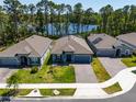Beautiful aerial view of a single-story home next to a pond and surrounded by tall trees at 6006 Mount Zion Cir, Deland, FL 32724