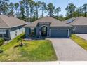 Inviting single-story home with well-kept landscaping, a two-car garage, and a welcoming front entrance at 6006 Mount Zion Cir, Deland, FL 32724