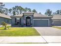 Charming single-story home with a two-car garage, neat landscaping, and an inviting front entrance at 6006 Mount Zion Cir, Deland, FL 32724