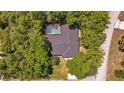 Aerial shot of a home with a pool, surrounded by dense trees, offering a private outdoor oasis at 639 Elwood St, Deltona, FL 32725