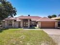 Charming brick home features a well-manicured lawn and a two-car garage at 685 Enterprise Osteen Rd, Osteen, FL 32764