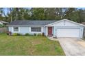 Well-maintained single-story home with a lush green lawn and traditional architectural details at 732 Mockingbird Ln, Deland, FL 32720