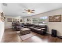 Spacious living room features hardwood floors, a ceiling fan, and a large sectional sofa at 732 Mockingbird Ln, Deland, FL 32720