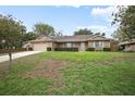Charming single-story brick home featuring an attached garage and a well-maintained lawn with mature landscaping at 808 Jutland St, Deltona, FL 32725