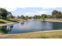Scenic pond with a fountain and surrounding greenery, creating a peaceful community atmosphere at 811 Grand Park Ct, Deland, FL 32724