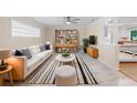 Cozy living room boasts a comfortable sofa, stylish rug, and decorative shelving unit at 825 Baltimore Dr, Orlando, FL 32810