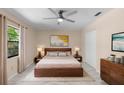 Serene main bedroom with a modern bed, warm lighting, and neutral decor at 825 Baltimore Dr, Orlando, FL 32810