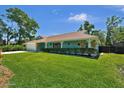 Inviting home showcasing a lush green lawn and tidy landscaping along the facade at 1 Cobblestone Trl, Ormond Beach, FL 32174