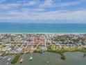 An aerial view shows the home and the surrounding neighborhood near the beach at 101 Egret Ave, Port Orange, FL 32127
