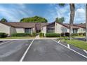 Well-kept condominium exterior with landscaped bushes and designated parking spaces at 101 Grand Plaza Dr # A30, Orange City, FL 32763