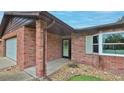 Close up of a brick home's covered front entrance showing a bay window and attached garage at 104 Nathan Hale Ct, Daytona Beach, FL 32119