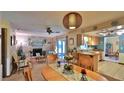 Cozy living and dining area with a brick fireplace and hardwood dining set at 104 Nathan Hale Ct, Daytona Beach, FL 32119