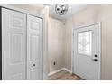 Bright foyer featuring a decorative front door with glass insert, tile floor, and coat closet at 105 Golfside Cir, Sanford, FL 32773