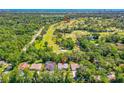 Aerial shot showcases the property's proximity to the Riviera Country Club and lush green surroundings at 105 Riviera Estates Blvd, Ormond Beach, FL 32174
