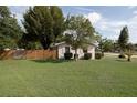 Well-maintained backyard with green lawn and mature trees, providing a private outdoor space at 1148 Briarwood Ave, Deltona, FL 32725