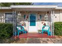 Inviting front porch featuring colorful decor, stone accents, and comfortable seating at 1148 Briarwood Ave, Deltona, FL 32725