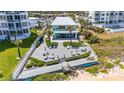 Beautiful exterior view showcasing the deck area, complemented by lush tropical landscaping and ocean views at 1167 Ocean Shore Blvd # 110, Ormond Beach, FL 32176